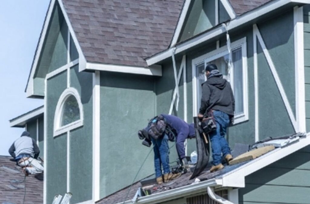 A Kings Roofing & Contracting roofer repairing cracked shingles on a Donnelly, ID home, improving roof stability and preventing moisture damage from local weather.