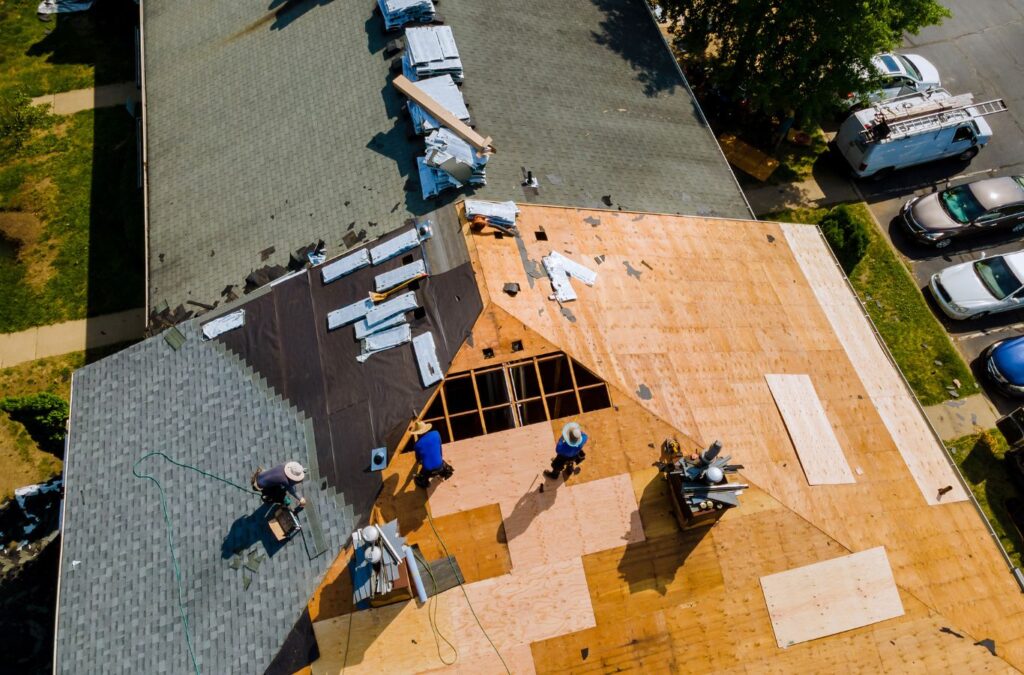 A Kings Roofing & Contracting roofer removing aging shingles during a roof replacement in Donnelly, ID, ensuring stronger weather protection and long-term performance.